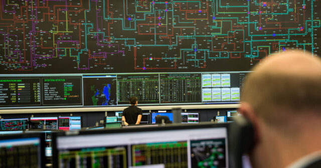 An employee monitors electricity output and usage data on a screen at the National Grid Plc control centre in Wokingham, U.K. on Friday, Oct. 30, 2015. U.K. electricity network operator National Grid Plc said it will "remain vigilant" on power supplies this winter amid slumping available generation capacity, with the tightest level expected in the week of Jan. 11. Photographer: Simon Dawson/Bloomberg via Getty Images