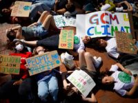 Young climate activists stage a "die-in" in Lafayette Park across from the White House on Earth Day on April 22, 2022 in Washington, DC. Organized by Fridays for Future DC, about 50 young people gathered to protest against the use of fossil fuels. (Photo by Chip Somodevilla/Getty Images)