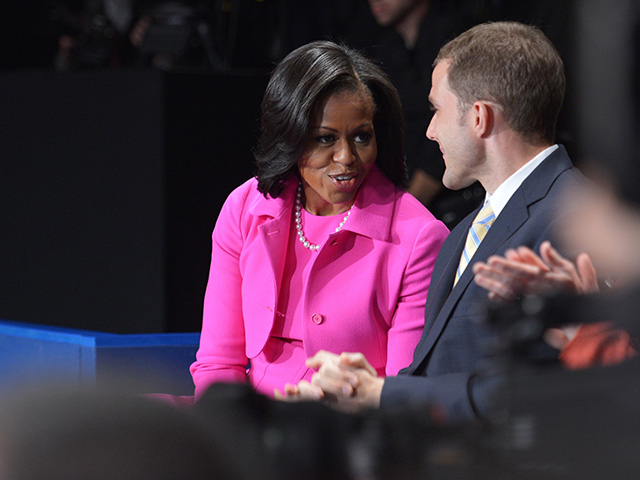 First Lady Michelle Obama chats with US Army veteran Seth Bodnar October 16, 2012 before the candidates arrive on stage for the second presidential debate at the David Mack Center at Hofstra University in Hempstead, New York. AFP PHOTO/Mandel NGAN (Photo credit should read MANDEL NGAN/AFP via Getty Images)