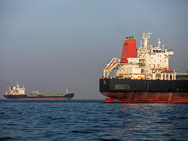 Ships remain anchored on May 16, 2026 in the Strait of Hormuz near Larak Island, Iran. Neg