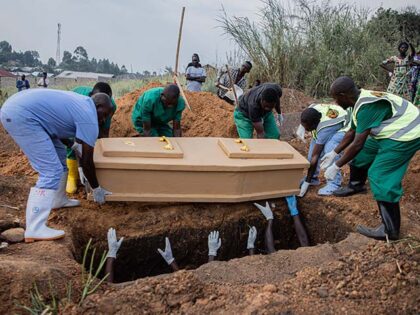 Medical workers bury a deceased person in accordance with epidemic prevention protocols in