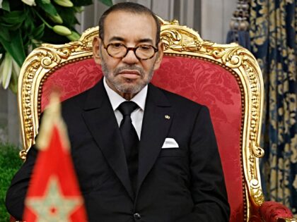 Morocco's King Mohammed VI sits next to France's President during a signing ceremony in th
