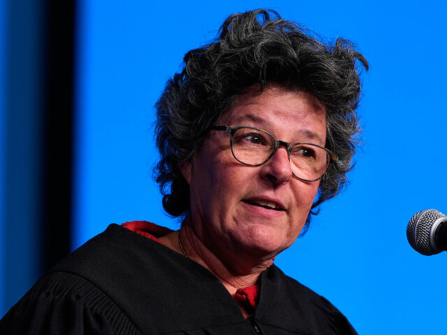 U.S. District Judge Allison Dale Burroughs addresses new citizens during a naturalization