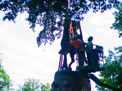 The monument of Stonewall Jackson is prepared to be lifted from its pedestal on Saturday,