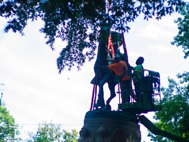 The monument of Stonewall Jackson is prepared to be lifted from its pedestal on Saturday,