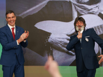 The President of the Government, Pedro Sanchez (left), presents an award to the musician E