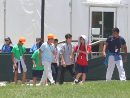 Children walk in the recreation yard at the Temporary Shelter for Unaccompanied Children.