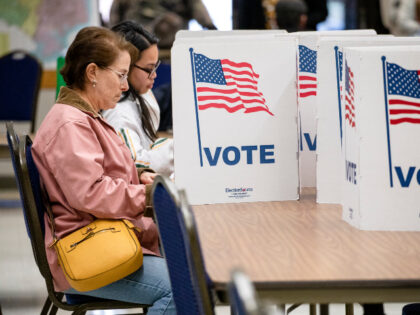 Women cast their votes in the Democratic presidential primary election at a polling locati
