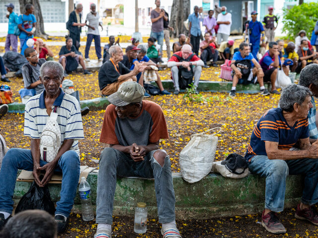 Local residents fill the benches of a public park during a combined religious service and