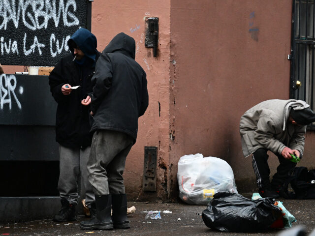 A person holds a foil while smoking following the decriminalisation of all drugs, includin
