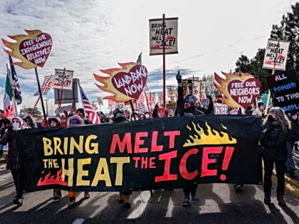 Indigenous and local activists march outside the Bishop Henry Whipple Federal Building dur