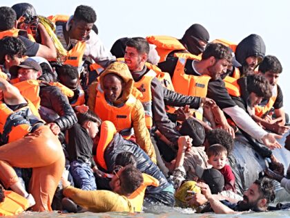 Illegal Migrants board a smugglers' boat in an attempt to cross the English Channel off th
