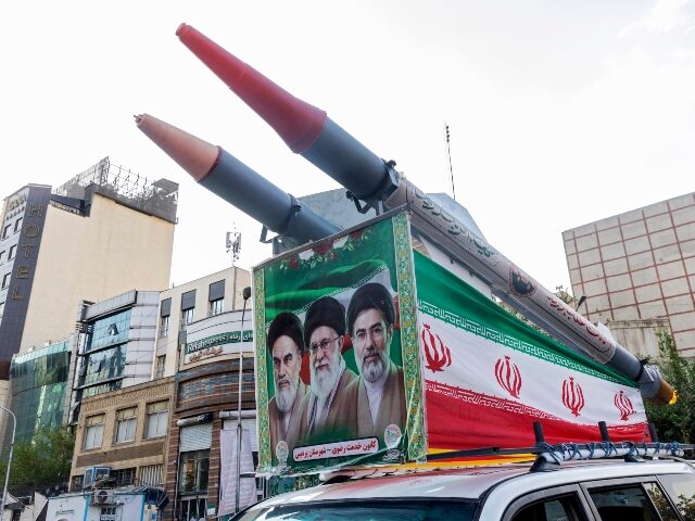 TEHRAN, IRAN - AUGUST 12: A car with replicas of missiles and an image of Iran's new