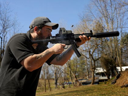 There's burst of smoke and ejecting shell as A.J. Wynne shoots a Heckler & Koch M