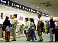 MIAMI - JULY 2: People wait in line to have their passports checked by Immigration inspectors July 2, 2002 at Miami International Airport in Miami, Forida. Inspectors are using the new multi-agency DataShare database which gives not only biographic information but also pictures of visa holders. At more than 300 ports of entry across the U.S. the new system is being used for visa holders who receive their documents at consular posts around the world. While information on immigrant visas has been available through DataShare since 1995, information on temporary visitors, or non-immigrants, has been widely available on DataShare only since January of this year. The addition of non-immigrant information to the DataShare system was put on a fast-track immediately following the September terrorist attacks. (Photo by Joe Raedle/Getty Images)