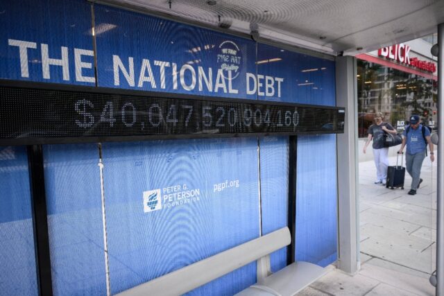 An electronic display shows the national debt in Washington, DC
