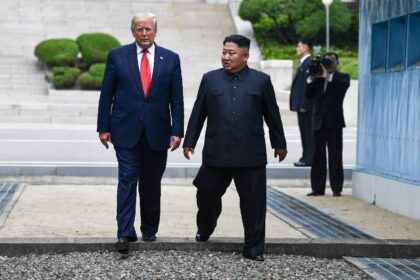 (FILES) North Korea's leader Kim Jong Un and US President Donald Trump cross south of