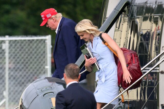 US President Donald Trump and aide Natalie Harp exit Marine One on the Ellipse near the Wh