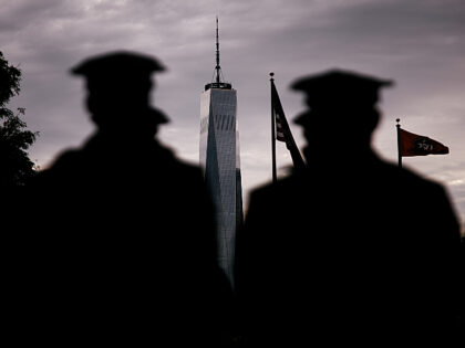 Police stand with One World Trade Center visible in the background as they participate in