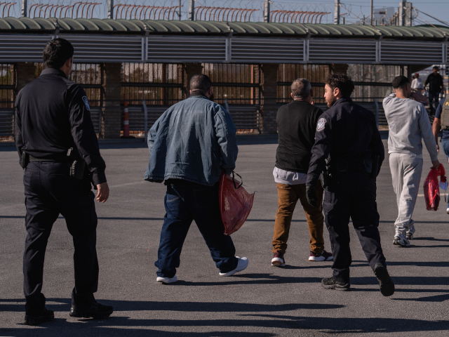 A group of undocumented migrants is escorted by U.S. Immigration and Customs Enforcement a