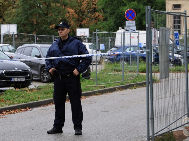 Croatia School Stabbing A police officer stands near the high school where a student stabbed and injured another s