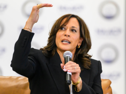 Former Vice President Kamala Harris speaks with the Rev. Wendell Anthony, President of the