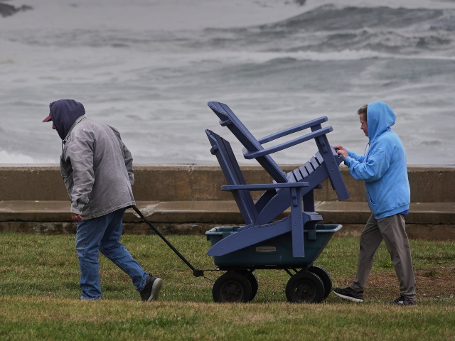 Chuck and Teresa Palmieri move lawn furniture to a safe location at a relative's seas