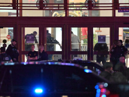 Local, state and federal agencies work at the crime scene at Brass Mill Center Mall on Uni