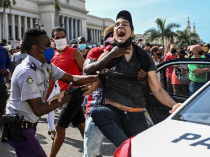 A man is arrested during a demonstration against the government of Cuban President Miguel