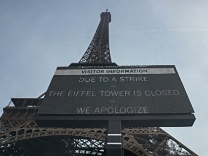 This photograph shows a view of a placard reading "Due to a strike the Eiffel Tower is clo