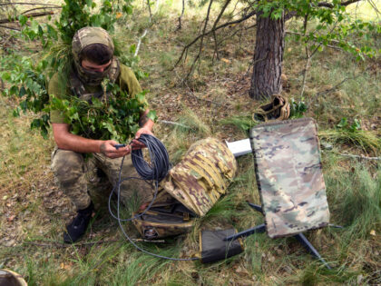A Ukrainian soldier of the 61st Separate Mechanized Brigade uses the Starlink system durin