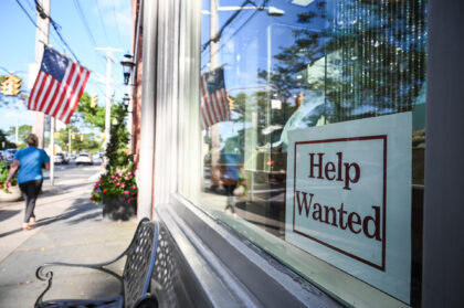 Sayville, N.Y.: A help wanted sign is posted in the storefront window of Kay Cameron Jewel