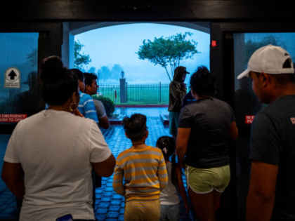 HOUMA, LOUISIANA - SEPTEMBER 11: Families watch Hurricane Francine from the entrance of th