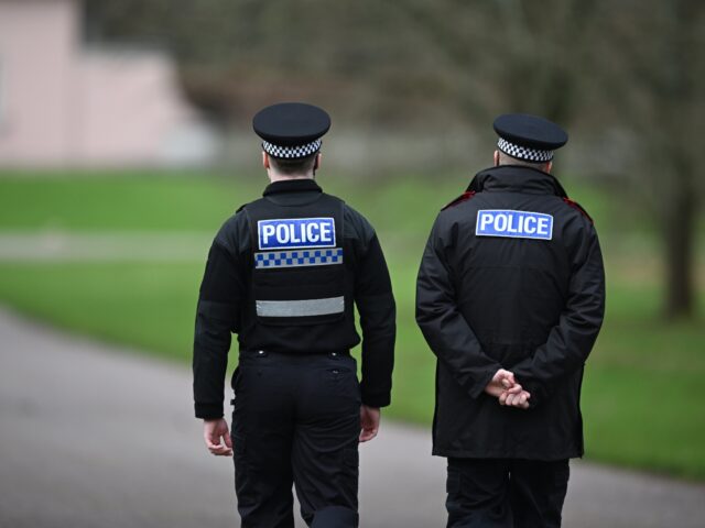 WINDSOR, ENGLAND - FEBRUARY 20: Police officers approach the gates of the Royal Lodge, And