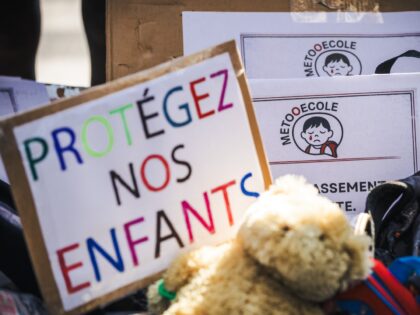 Protesters placed schoolbags on the pavement, along with soft toys and placards bearing th