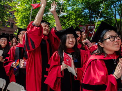Student graduates cheer as degrees are conferred onto them in Harvard Yard during the 175t