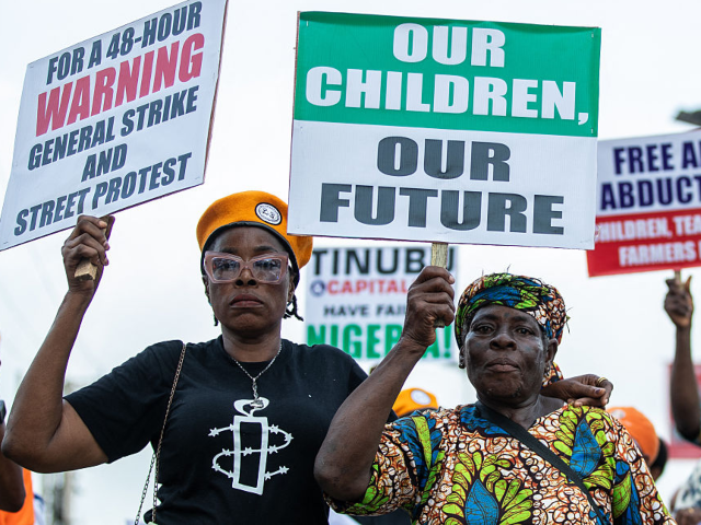 Protesters march on the street of Ojota in Lagos during the Jun 12 celebrations marking th