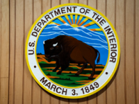 WASHINGTON, DC - JULY 10: The logo for the U.S. Department of the Interior, on the final day of the Great American State Fair on July 10, 2026 in Washington, DC. The DOI is responsible for managing and conserving most of the nation's public lands, natural resources, and cultural heritage. (Photo by Al Drago/Getty Images)