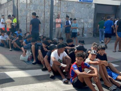 CEUTA, SPAIN - AUGUST 10: A group of minors wait to be registered at a National Police sta