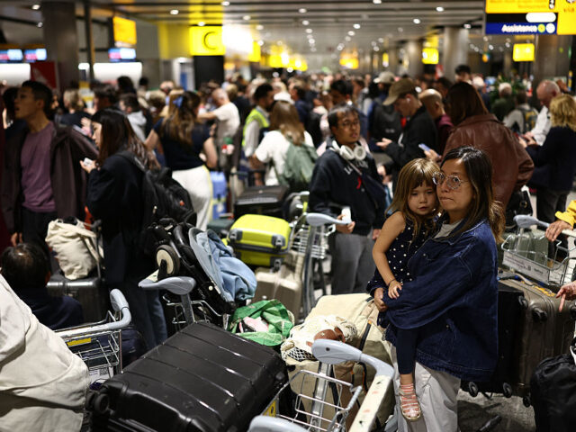 TOPSHOT-BRITAIN-ECONOMY-AVIATION-NATS TOPSHOT - Delayed passengers wait and queue with their luggage at Terminal 3 of London Hea