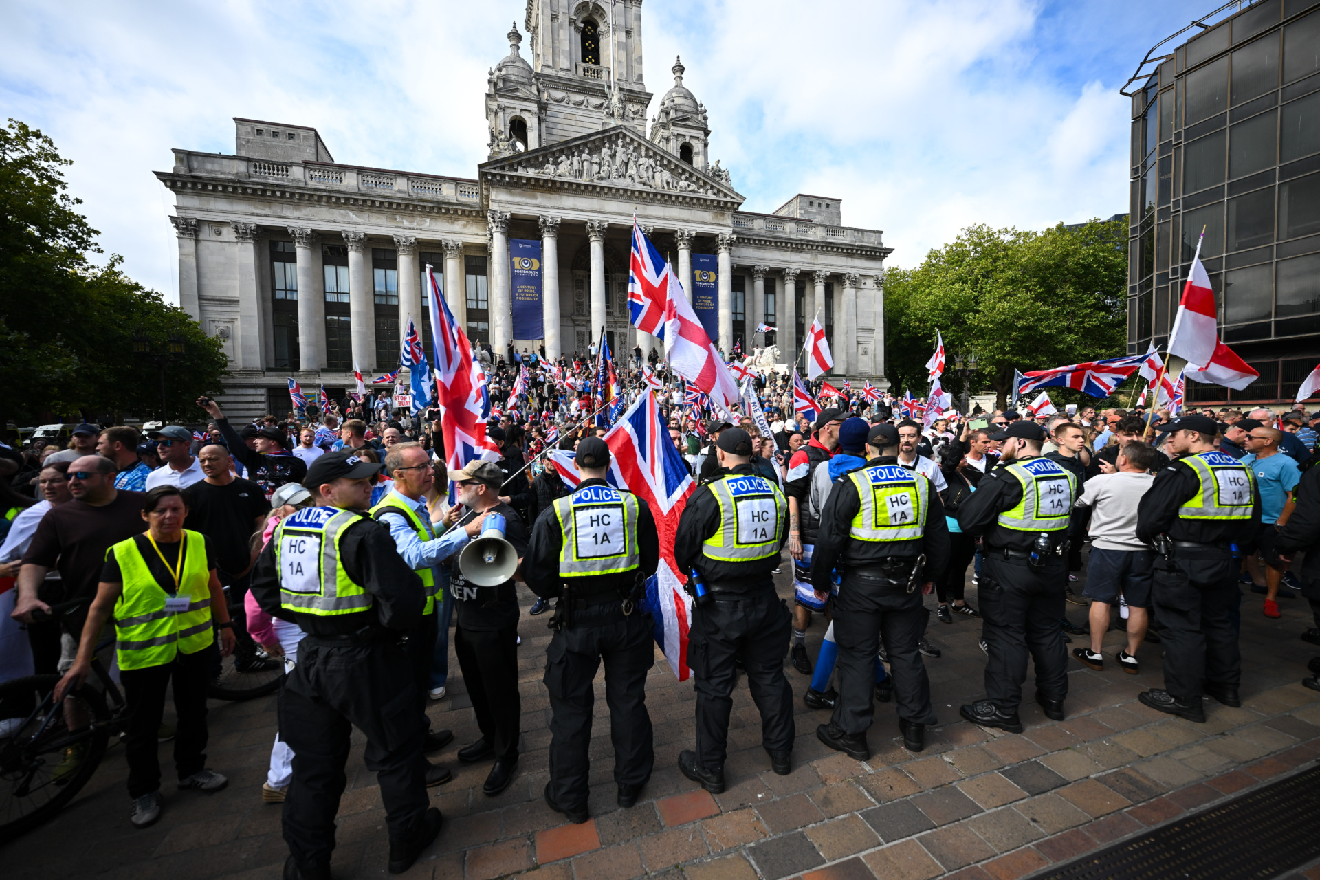 PORTSMOUTH, ENGLAND - SEPTEMBER 12: Demonstrators participate in an anti-migrant march through the city to Guildhall, on September 12, 2026 in Portsmouth, England. A volunteer RNLI crew rescued approximately 140 migrants from a