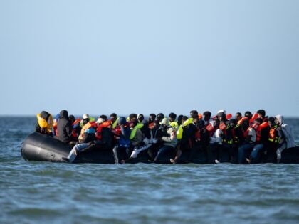 Migrants aboard a smugglers' boat attempt to cross the English Channel off the beach of Me