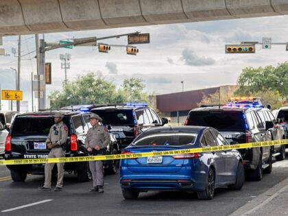 AUSTIN, TEXAS - SEPTEMBER 20: Law enforcement monitor a vehicle that was shot at by Immigr