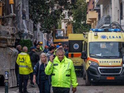 Emergency personnel work after an old building partially collapsed following an explosion