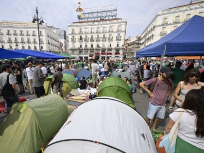 MADRID, SPAIN - SEPTEMBER 27: Protesters, holding banners and flags, gather and pitch tent