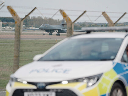 RETRANSMITTED CORRECTING DATE Police patrol the perimeter as a US Air Force Rockwell B-1 L