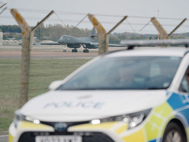 RETRANSMITTED CORRECTING DATE Police patrol the perimeter as a US Air Force Rockwell B-1 L