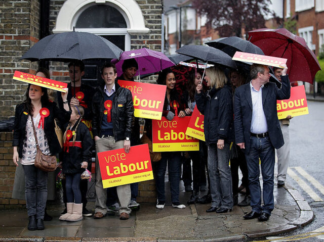 Gordon Brown Campaigns in Constituencies Across London LONDON, ENGLAND - MAY 02: Labour supporters shelter from the rain while waiting for Gordo