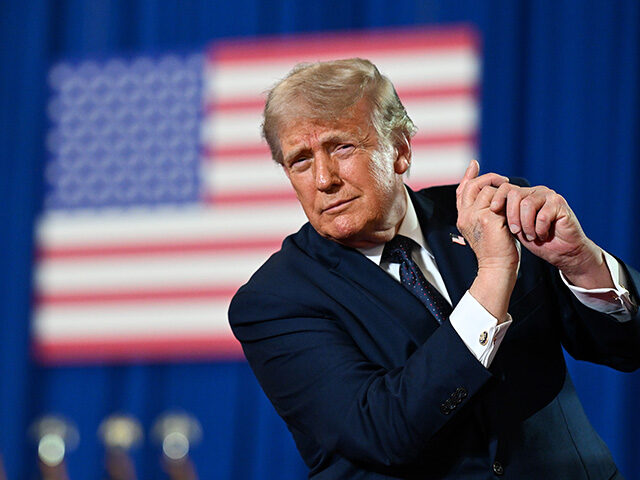 U.S. President Donald Trump dances on stage after delivering remarks during a campaign and