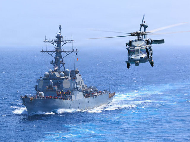 HNiDJhQXwAA48SW USS Donald Cook (DDG 75) transits the Arabian Sea while an MH-60S Sea Hawk flies nearby. A